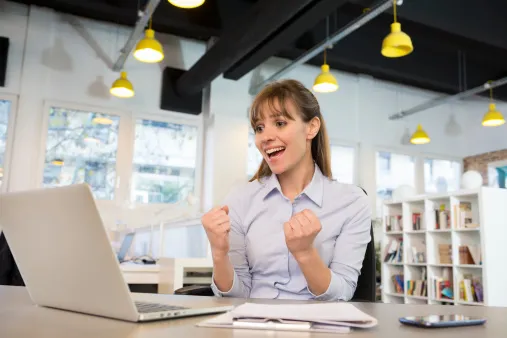 double fist pump laptop woman
