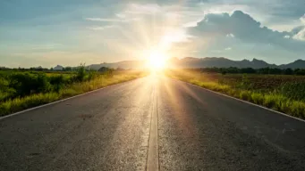 empty road with a sunset at the end