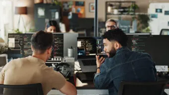 Image of 2 developers using secure coding with OpenText and Secure Code Warrior
