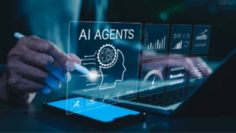 Person at laptop with smartphone monitoring AI agents at work