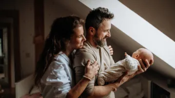 Couple holding newborn baby