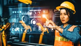 Woman in manufacturing using AI and IoT to optimize operations