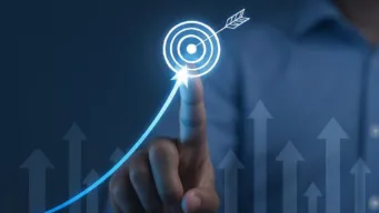 worker's finger touching target on screen; arrows are pointing up in background, inidcating OpenText leads in the GigaOm Radar cloud performance testing report