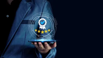 A hand extended holding a graphic depiction of a medal and 5 stars.