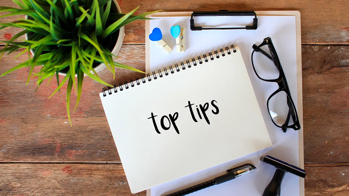 This is an image of pad of paper, glasses and a booklet of top search tips.