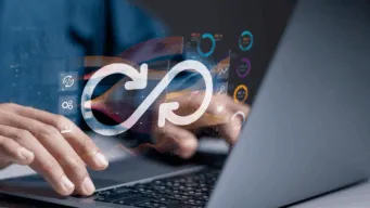 Open laptop with a developer working on it. There is a devops invinity loops hovering over the keyboard indicating agile testing throughout the SDLC.