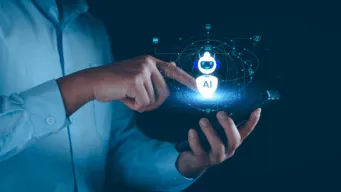 a midshot of a male worker holding a mobile device in one hand and pointing to it, "dragging" an AI "robot" icon around, as it acts like a digital worker