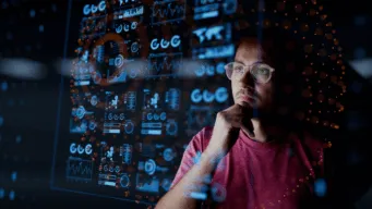 A male developer looking at code superimposed in the foreground and contemplating how there may be an initial AI slow down for experienced developers, but that can be avoided with the right AI in the right place.