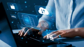 A close up of hands typing on a laptop with icons demonstrating an intelligent workflow imposed on top.