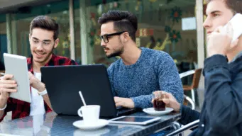 Users looking at laptop, tablet and using mobile phone