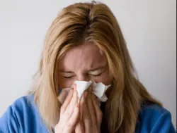 woman blowing her nose